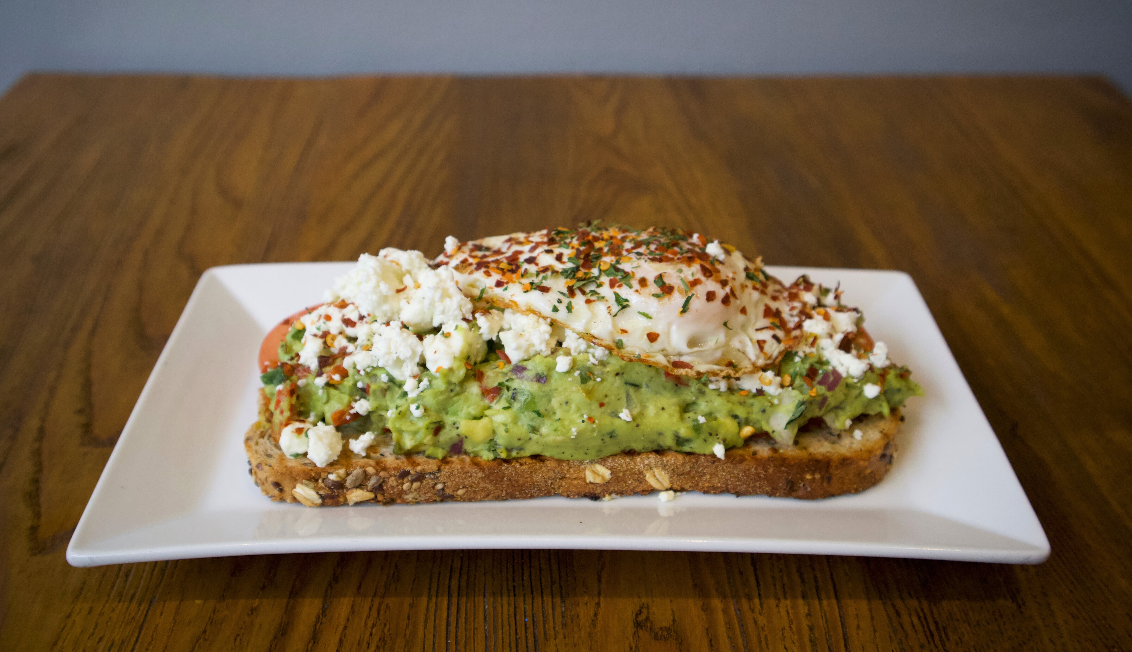Goat cheese avocado toast with poached egg